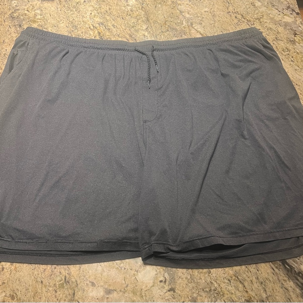 Reebok 6X grey shorts. 92% poly 8% spandex. Zippered pocket(s)